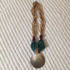 Neutral and dark turquise toned statement necklace.